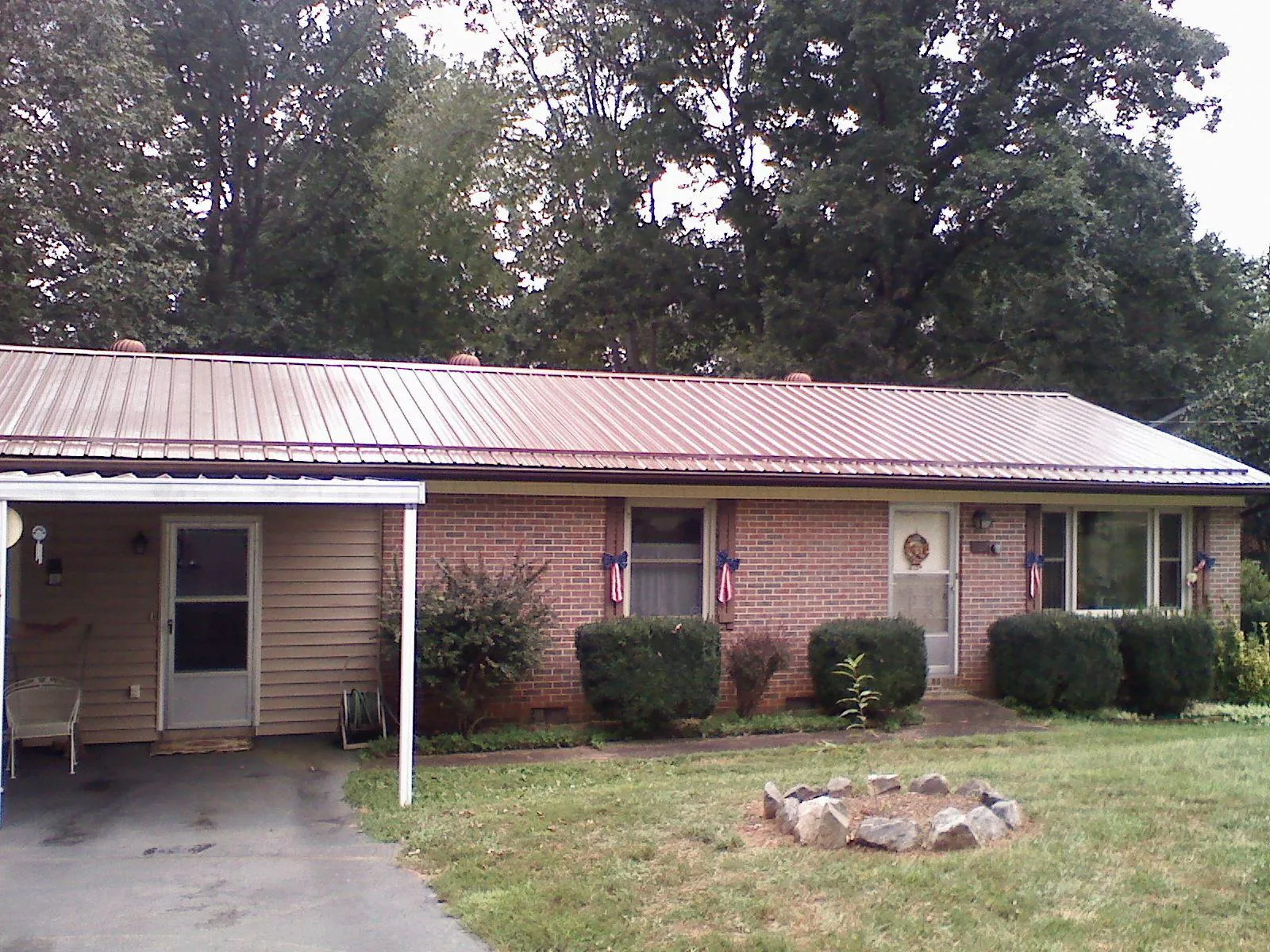 Bronze metal roof and carport on a brick ranch home — Roof Repair work by our crew in Egg Harbor